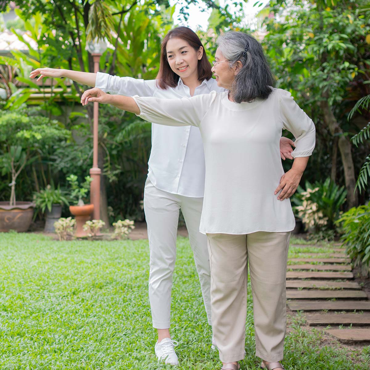 image of caregiver helping elderly patient get exercise outside