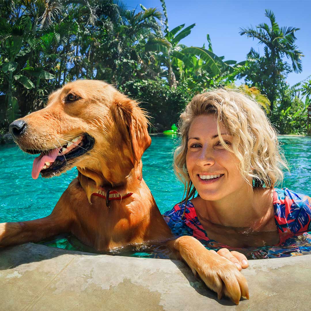 image of woman in the pool with her dog in Hawaii.